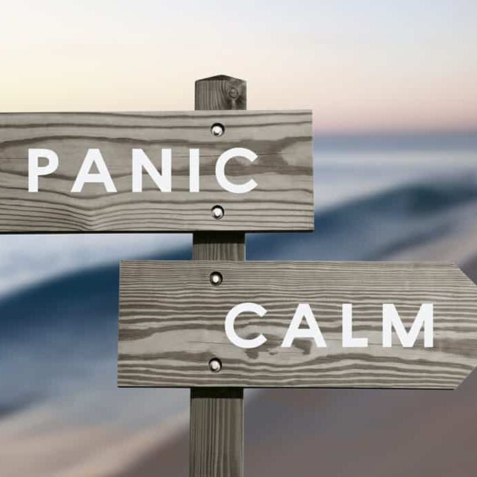 Calm vs Panic signs with blurred beach background